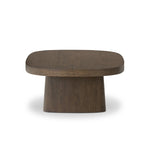 Made from rustic brown oak, a rectangular coffee table is streamlined while not short on presence, with its exaggerated cylinder legs and polished pill-shaped top Amethyst Home provides interior design, new home construction design consulting, vintage area rugs, and lighting in the Houston metro area.