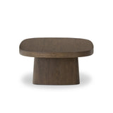 Made from rustic brown oak, a rectangular coffee table is streamlined while not short on presence, with its exaggerated cylinder legs and polished pill-shaped top Amethyst Home provides interior design, new home construction design consulting, vintage area rugs, and lighting in the Houston metro area.
