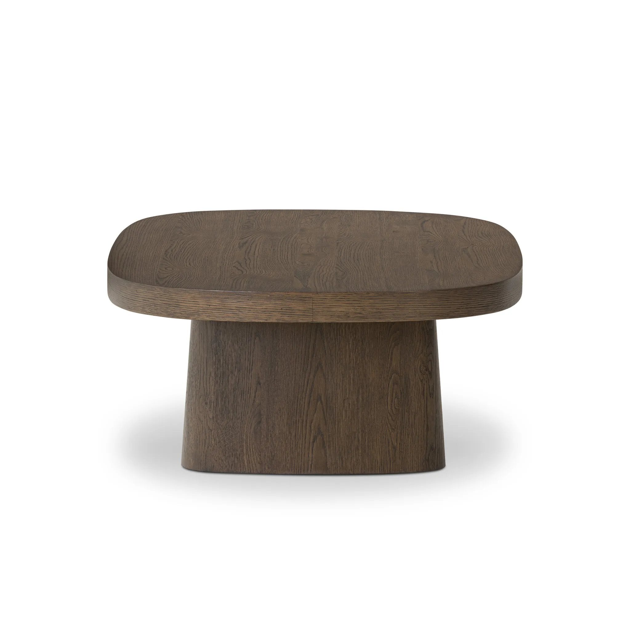 Made from rustic brown oak, a rectangular coffee table is streamlined while not short on presence, with its exaggerated cylinder legs and polished pill-shaped top Amethyst Home provides interior design, new home construction design consulting, vintage area rugs, and lighting in the Houston metro area.