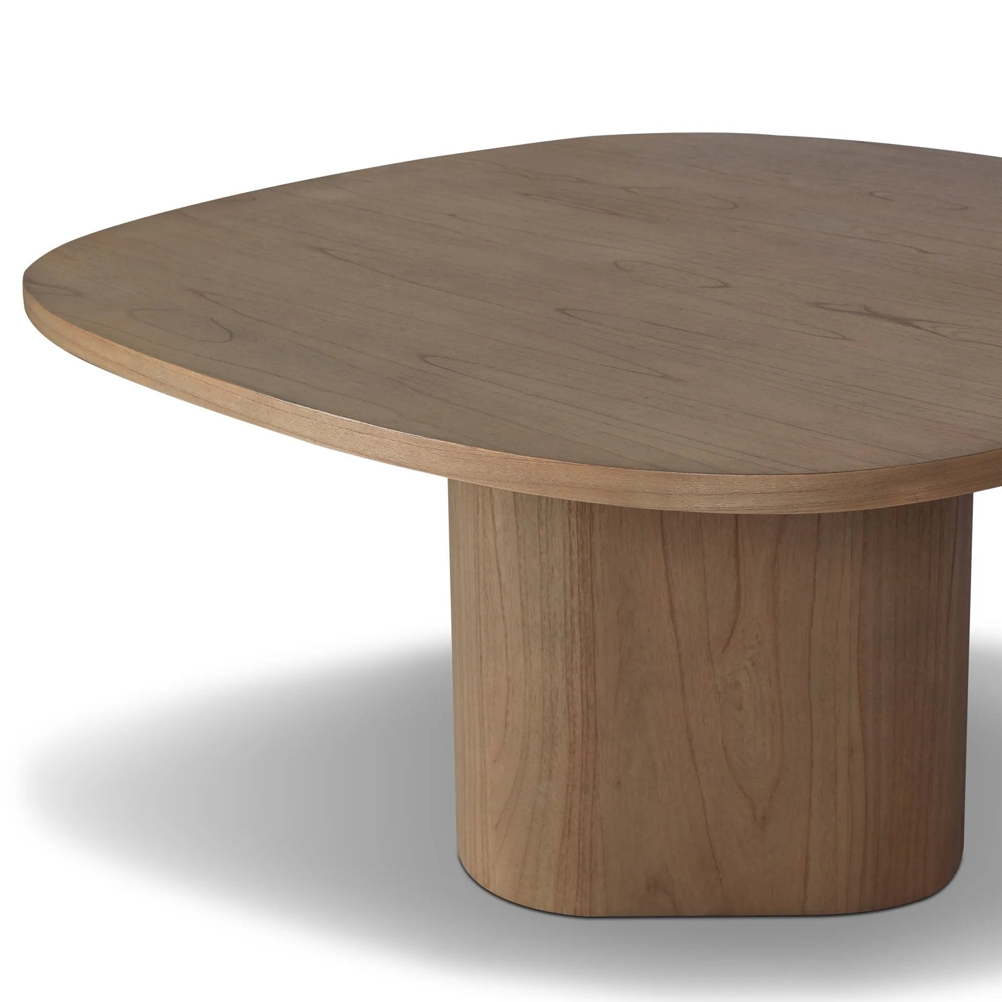 Center your dining space with a beautifully simple style inspired by soft Brutalism. Made from solid mindi with a light, sandy finish, this monolithic piece features a unique "squircle" tabletop, with flowing curves on its edges. A substantial plinth base is rotated to a 45-degree angle to highlight this piece's playful shaping Amethyst Home provides interior design, new home construction design consulting, vintage area rugs, and lighting in the Dallas metro area.
