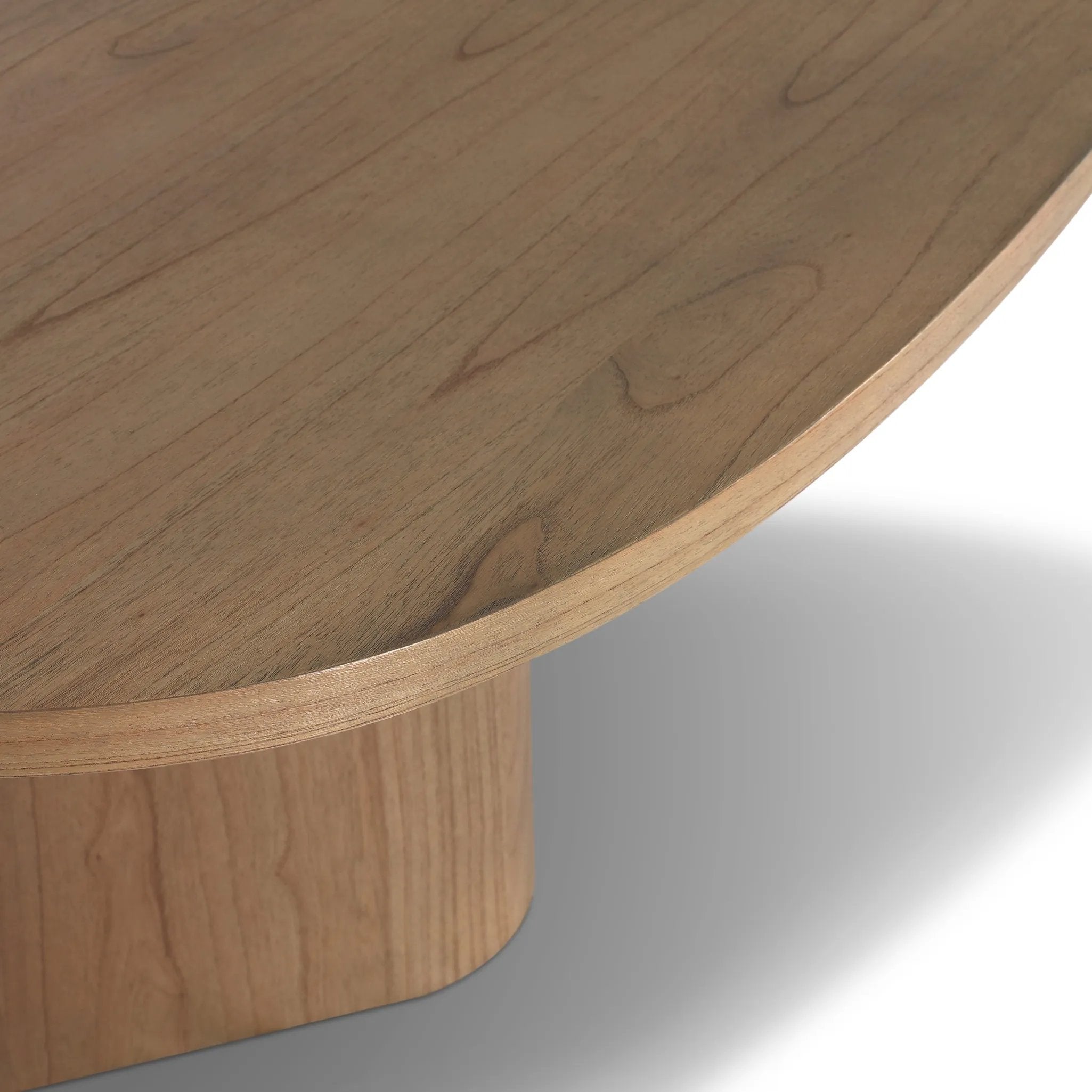 Center your dining space with a beautifully simple style inspired by soft Brutalism. Made from solid mindi with a light, sandy finish, this monolithic piece features a unique "squircle" tabletop, with flowing curves on its edges. A substantial plinth base is rotated to a 45-degree angle to highlight this piece's playful shaping Amethyst Home provides interior design, new home construction design consulting, vintage area rugs, and lighting in the Los Angeles metro area.