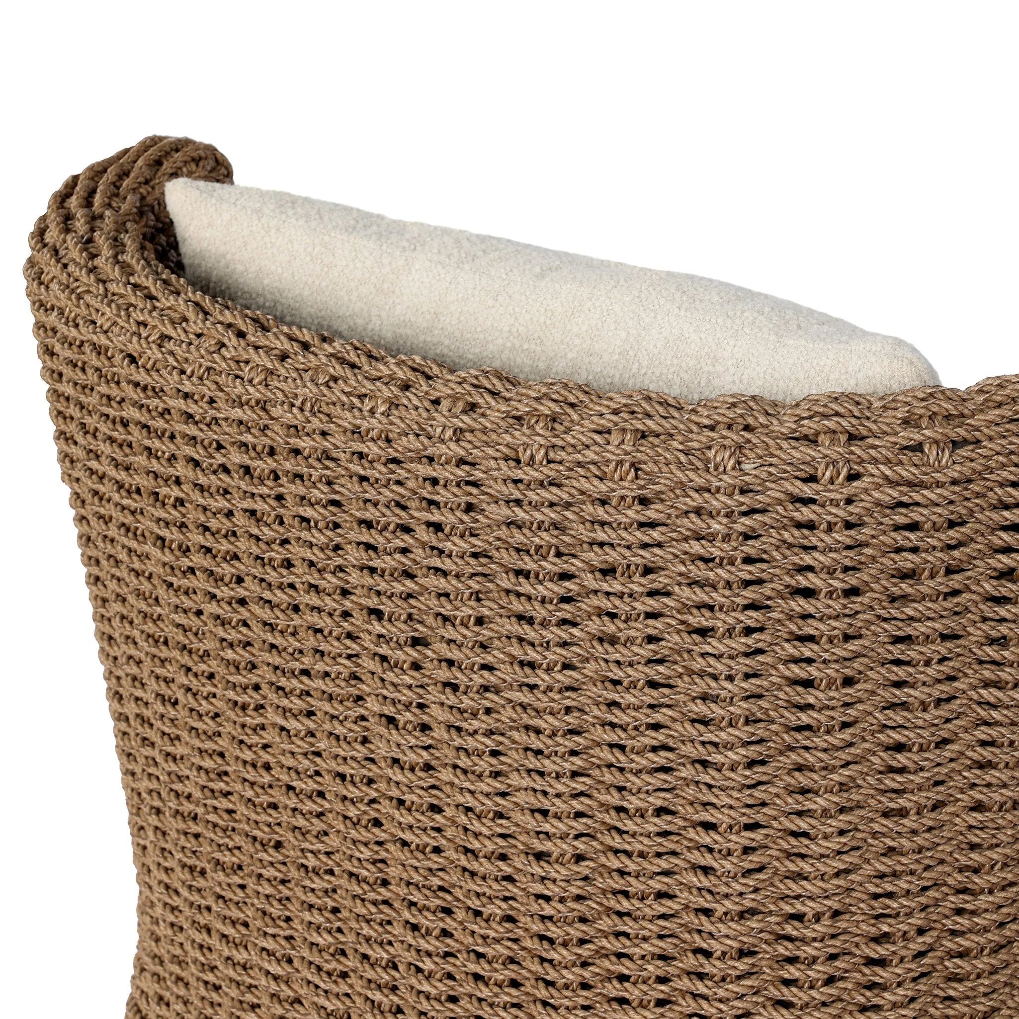 This outdoor chair's sculpted shape mimics classic wingback armchairs, with a double-twist woven material framing heavily textured boucle fabric for added visual weight. Cover or store inside during inclement weather or when not in use. Amethyst Home provides interior design, new home construction design consulting, vintage area rugs, and lighting in the Houston metro area.