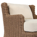 This outdoor chair's sculpted shape mimics classic wingback armchairs, with a double-twist woven material framing heavily textured boucle fabric for added visual weight. Cover or store inside during inclement weather or when not in use. Amethyst Home provides interior design, new home construction design consulting, vintage area rugs, and lighting in the Omaha metro area.
