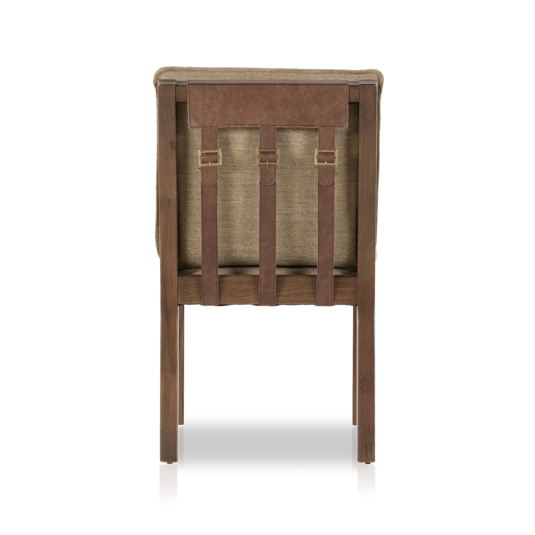 Featuring Wilmington Alcala Fawn Dining Chair by Four Hands at Amethyst Home. An Amethyst fave -- the Wilmington dining chair has a gorgeous coffee colored textile paired with medium toned wood and interesting leather buckles on the back -- we tied in the gold buckles with the gold chandelier above!  Inspired by the folded pillow form, the seat and back cushio. Amethyst Home provides interior design, new home construction design consulting, vintage area rugs, and lighting in the Austin metro area.