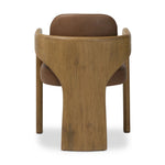 Striking from every view. This statement-making dining chair combines solid oak in tripod form with top-grain leather. The cantilever design, with a wide plank back and sloping arms, form an eye-catching silhouette for the floating seat and overflowing back cushion. Amethyst Home provides interior design, new home construction design consulting, vintage area rugs, and lighting in the Salt Lake City metro area.
