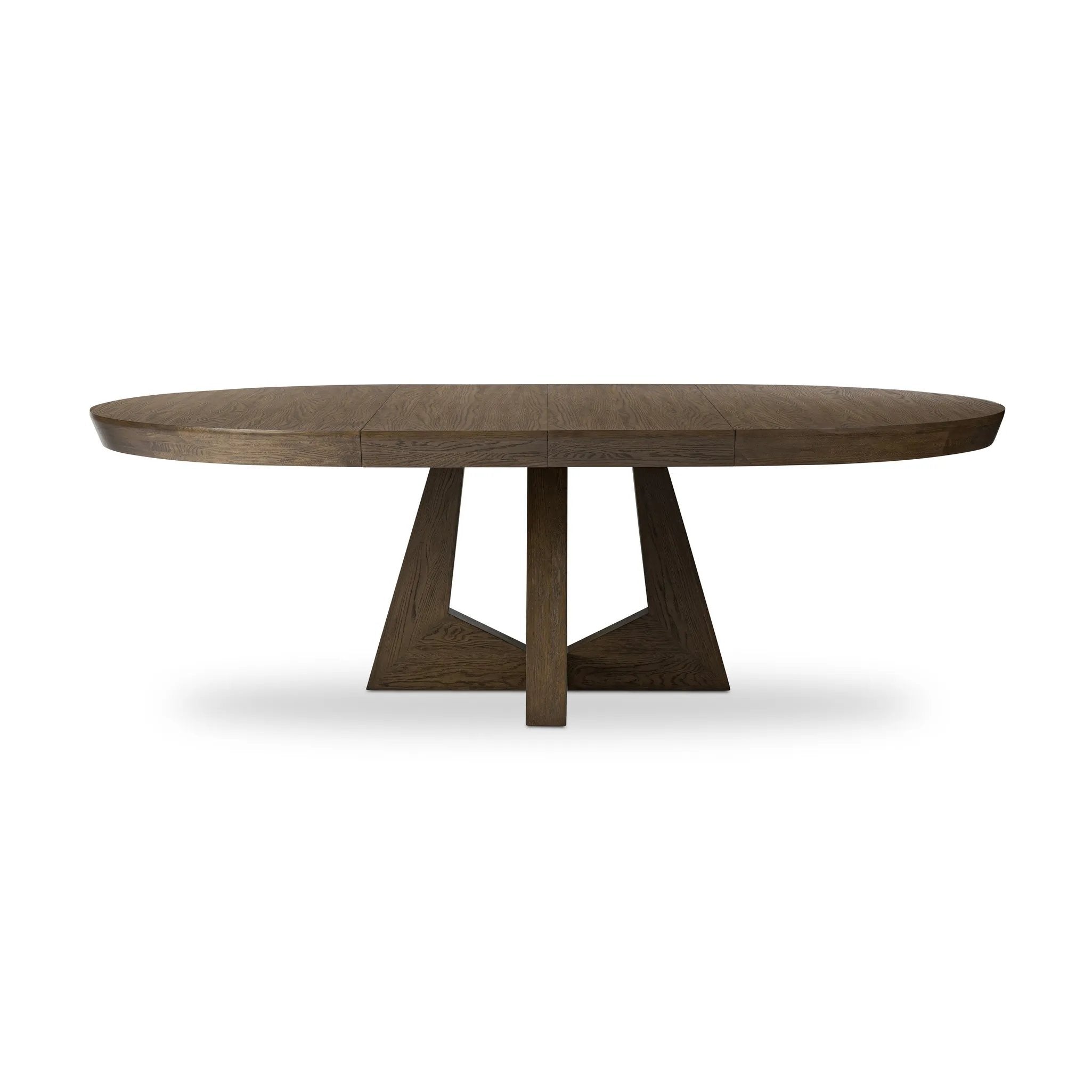 Sculptural angles define this expansive oak dining table, as angled cutouts play up a tapered base and top. Expandable design includes two leaves, easily extending from 77" to 94", for intimate gatherings and dinner parties alike Amethyst Home provides interior design, new home construction design consulting, vintage area rugs, and lighting in the Alpharetta metro area.