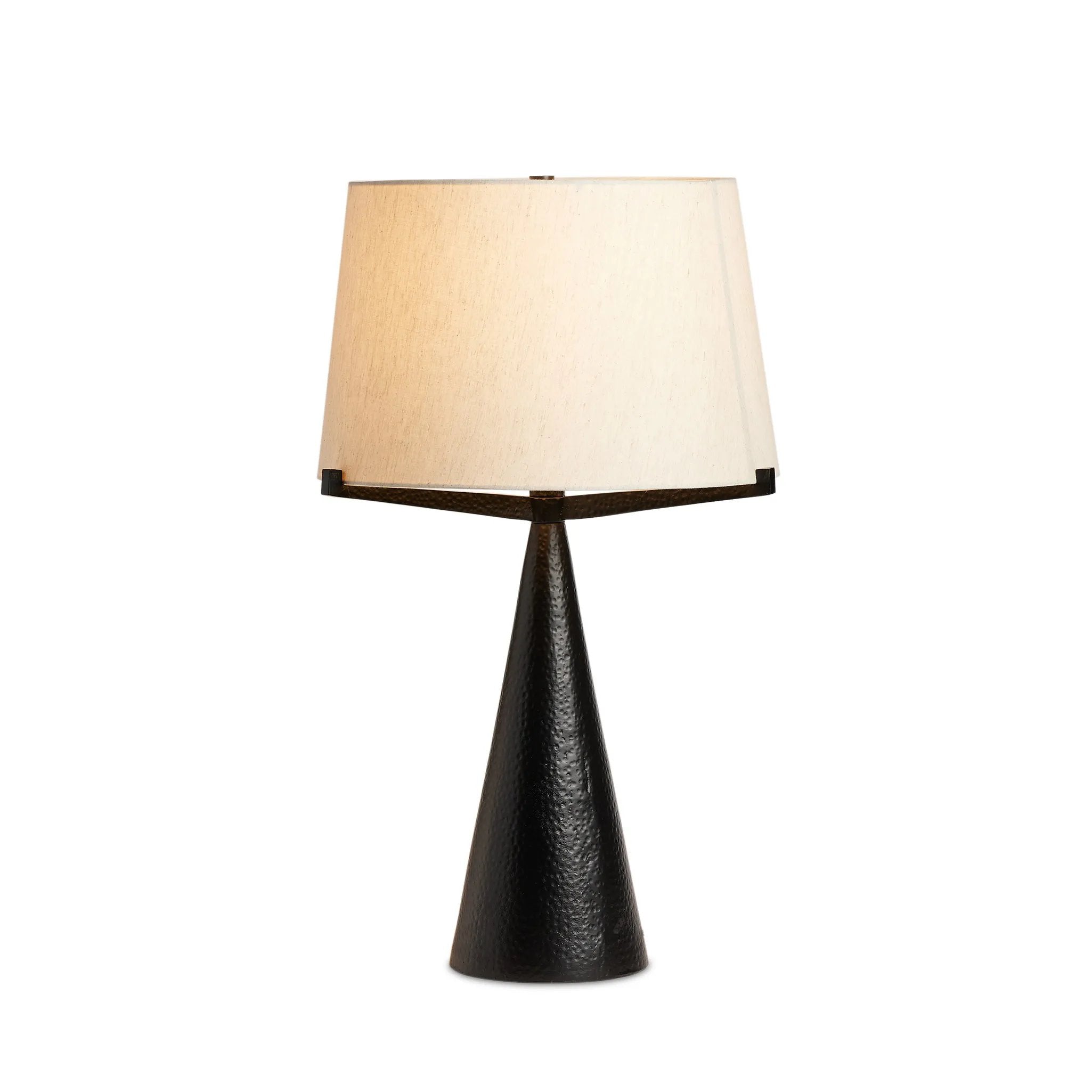 A tapered silhouette in black, hand-hammered aluminum gives this architectural table lamp its textured shape. A beige cotton shade adds a casual look with contrast Amethyst Home provides interior design, new home construction design consulting, vintage area rugs, and lighting in the Newport Beach metro area.