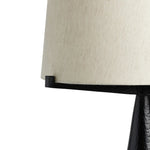 Featuring Ziggy Hammered Black Aluminum Table Lamp by Four Hands at Amethyst Home. A tapered silhouette in black, hand-hammered aluminum gives this architectural table lamp its textured shape. A beige cotton shade adds a casual look with contrast.Overall Dimensions: 19.00"w x 19.00"d x 31.00"hWeight : 11.50 lbsMaterials : Aluminum, Thermoplastic. Amethyst Home provides interior design, new home construction design consulting, vintage area rugs, and lighting in the Park City metro area.
