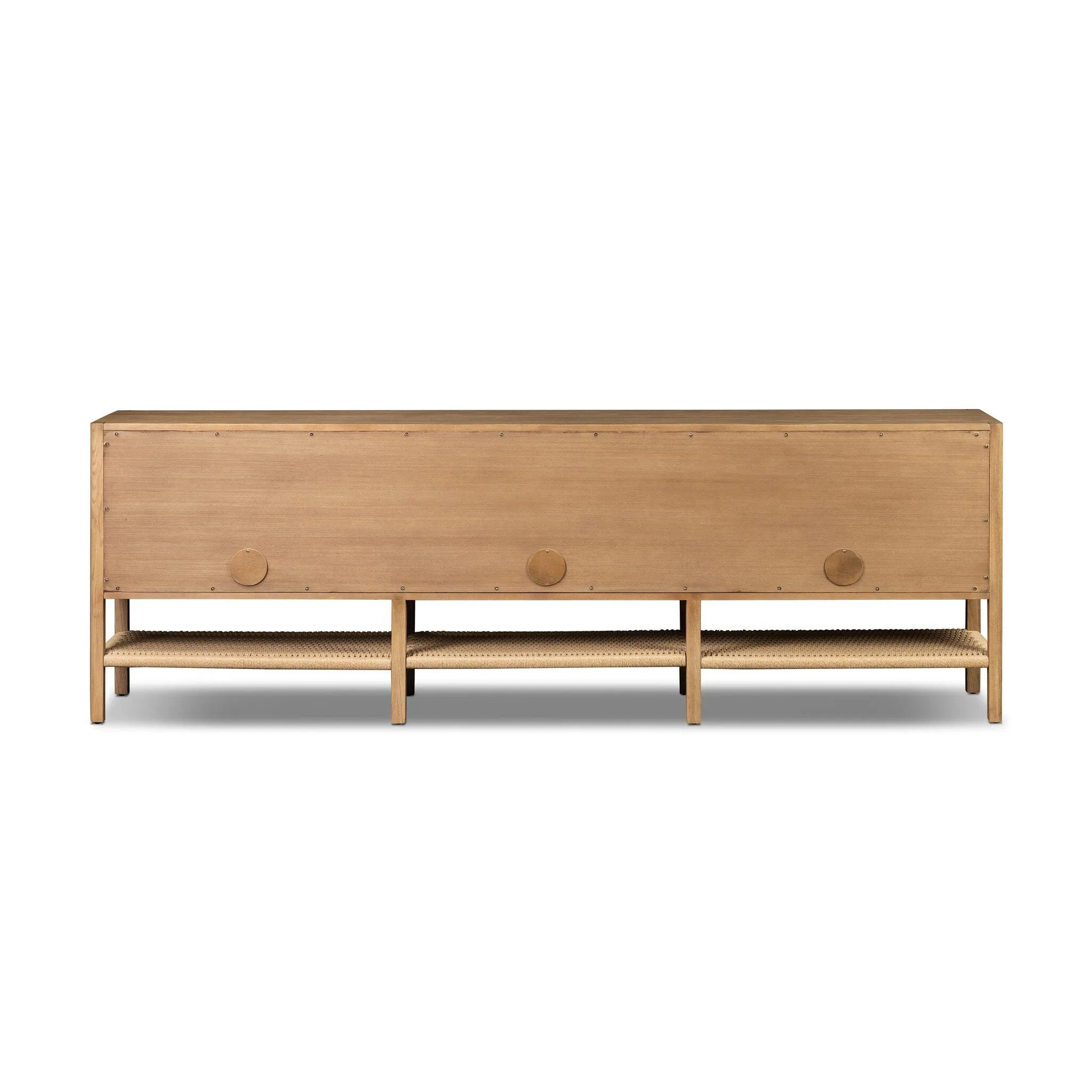 Simple yet refined, a Danish design-influenced sideboard is made from light-finished ash, with iron hardware finished in a sleek gunmetal. Perfect for larger spaces, with six doors and generous interior storage. Stretcher-style shelving made from woven paper cord serves up a textural finishing touch. Amethyst Home provides interior design, new home construction design consulting, vintage area rugs, and lighting in the Dallas metro area.
