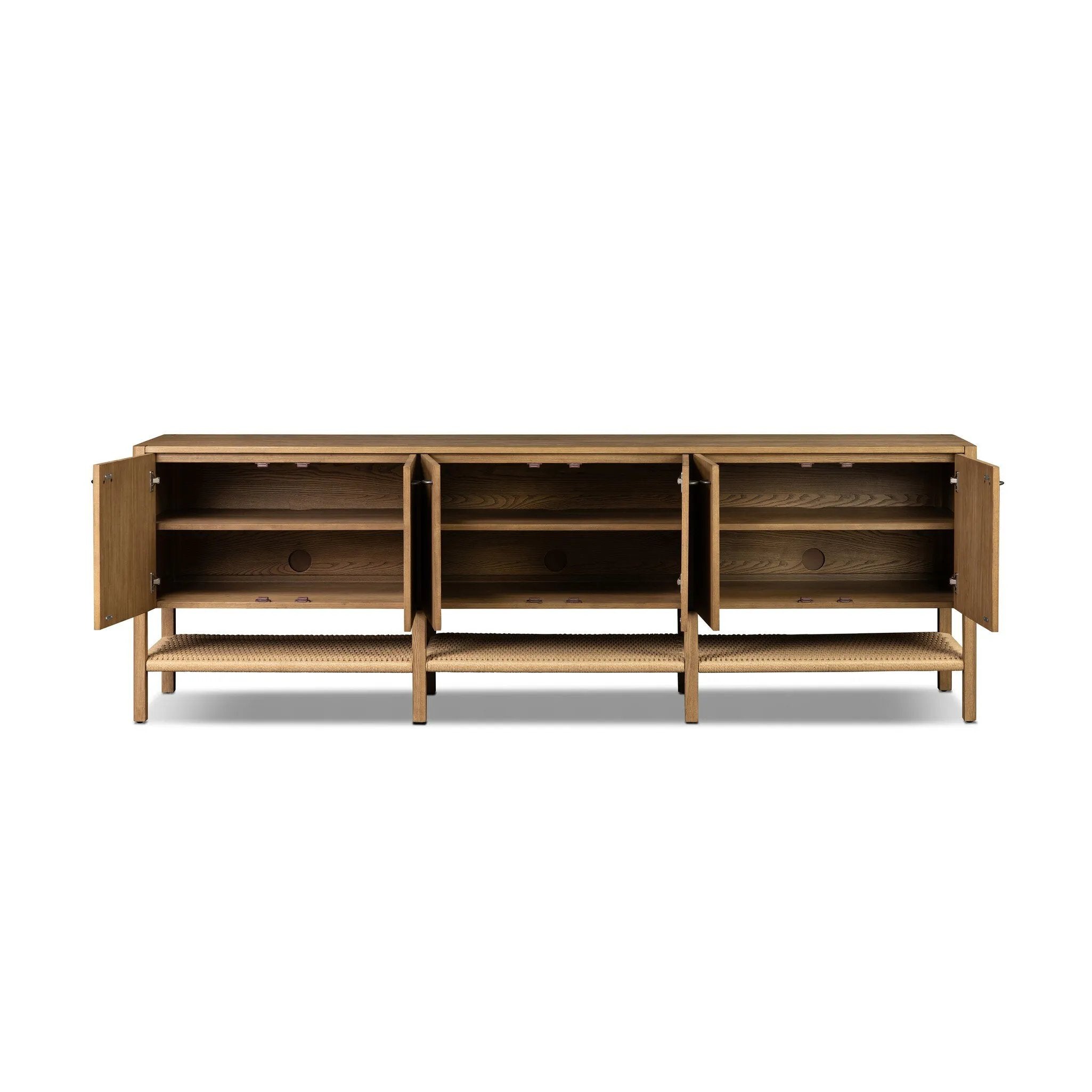 Simple yet refined, a Danish design-influenced sideboard is made from light-finished ash, with iron hardware finished in a sleek gunmetal. Perfect for larger spaces, with six doors and generous interior storage. Stretcher-style shelving made from woven paper cord serves up a textural finishing touch. Amethyst Home provides interior design, new home construction design consulting, vintage area rugs, and lighting in the Laguna Beach metro area.