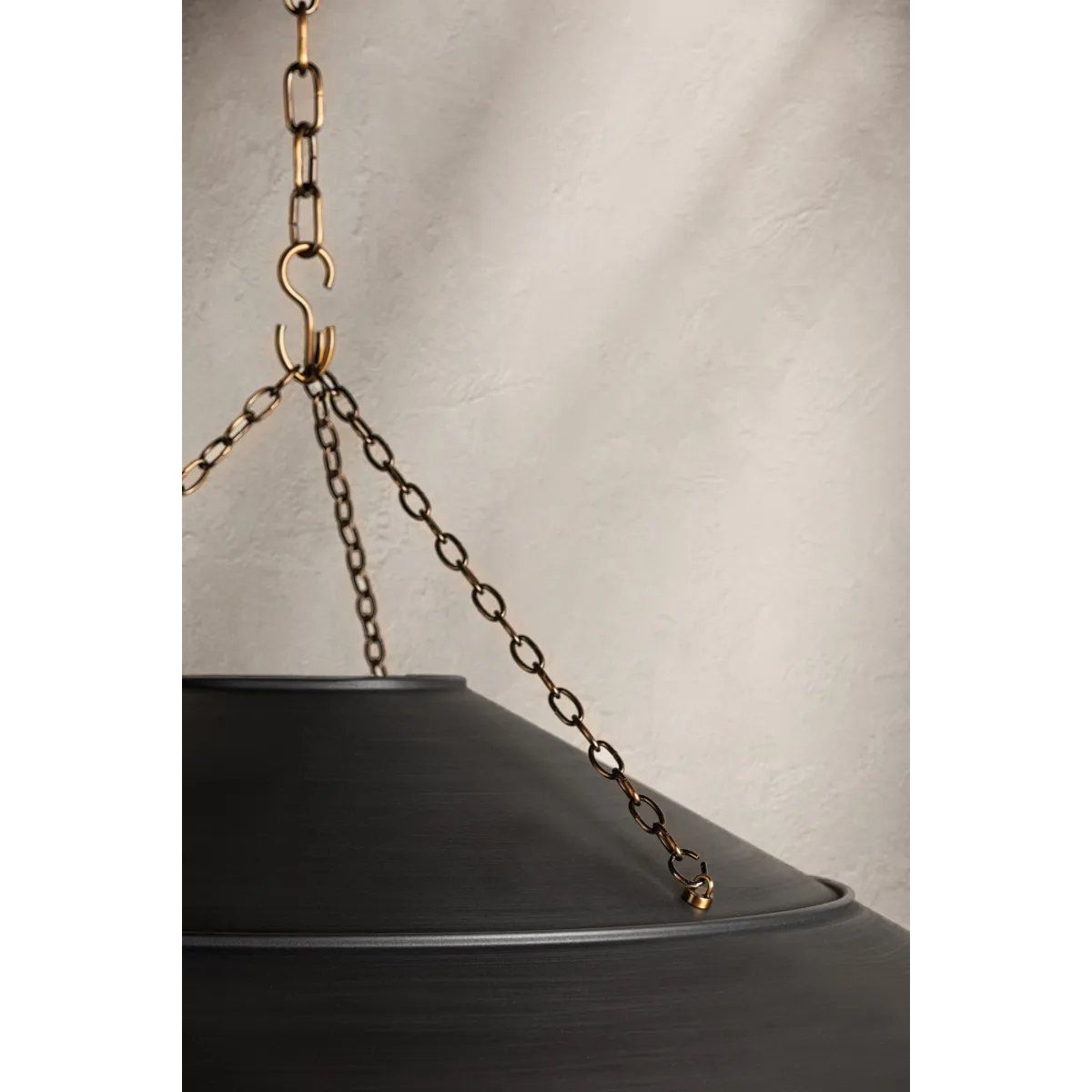 With its exposed metalwork, chain detailing, and unique finish combination, Arcane has an elevated, industrial vibe. The graphite shade feels chic and gives off a warm glow. The Patina Brass hardware, chain, and canopy add a hint of shine that plays wonderfully off the graphite. Amethyst Home provides interior design, new home construction design consulting, vintage area rugs, and lighting in the Monterey metro area.