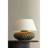 The Arlin family of table lamps pairs sculptural form with rich texture. Patterned metal bases feature a swirling motif that wraps each vessel shape, offered in two silhouettes: a fuller, more rounded form in Black Patina and a taller, generous form in Bronze Patina. Amethyst Home provides interior design, new home construction design consulting, vintage area rugs, and lighting in the Houston metro area.