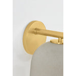 Inspired by Neoclassical architecture, Cara uses a domed shade and textural ceramic finish for a sconce that feels both ancient and new. A matte reactive glaze in an creamy hue creates a subtle surface grain that imitates natural stone. A circular modern armback in an Aged Brass finish adds shine to the fixture.  Amethyst Home provides interior design, new home construction design consulting, vintage area rugs, and lighting in the Winter Garden metro area.