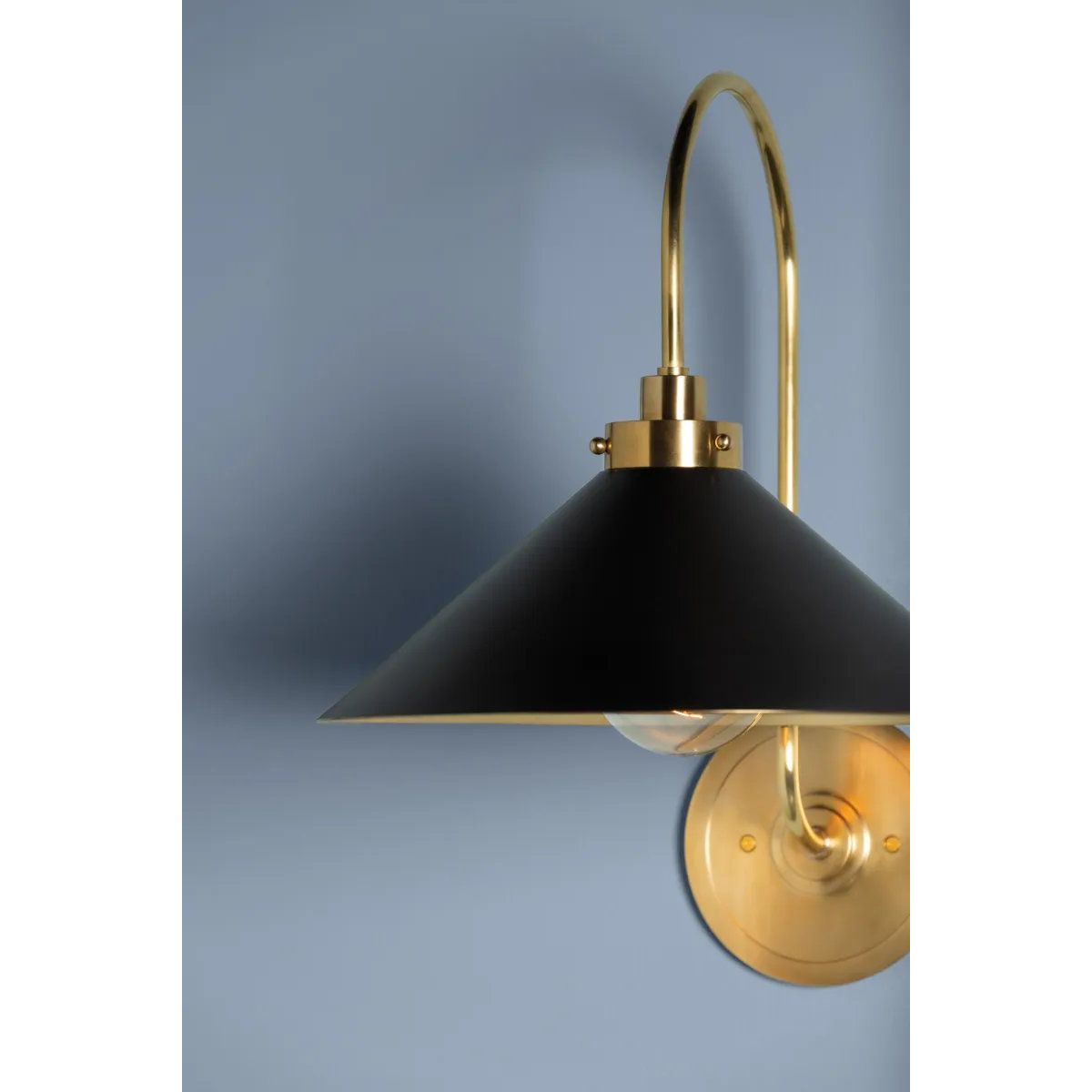 This classic metal shade design feels special with fresh finish combinations and sleek, heritage-inspired details. The contrastiing Aged Brass accents and modern gooseneck arm allow the pendants and sconce an updated, yet classic feel. The tapered shade over a five-light candelabra give the chandelier new traditional appeal. Amethyst Home provides interior design, new home construction design consulting, vintage area rugs, and lighting in the Houston metro area.