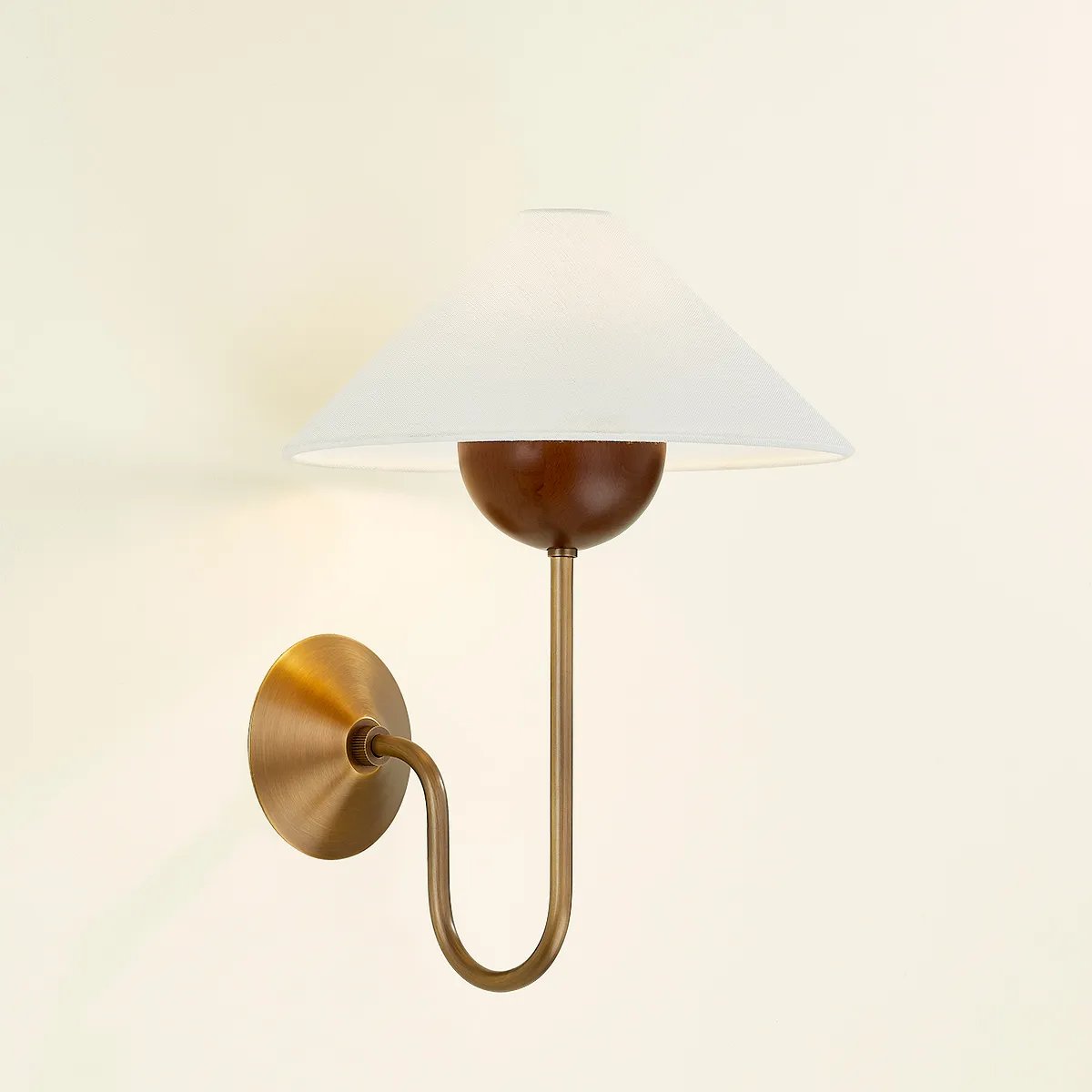 Combining geometric shapes and three distinctive earthy materials, the Evan sconce generates its own visual design language. The design-forward composition includes a swooping J-arm in Patina Brass, leading into an overscale walnut wood bobeche. As a note of contrast, the fixture is topped by a sharply tapered shade made from grained white linen.  Amethyst Home provides interior design, new home construction design consulting, vintage area rugs, and lighting in the Monterey metro area.