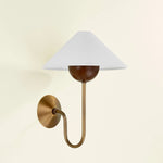 Combining geometric shapes and three distinctive earthy materials, the Evan sconce generates its own visual design language. The design-forward composition includes a swooping J-arm in Patina Brass, leading into an overscale walnut wood bobeche. As a note of contrast, the fixture is topped by a sharply tapered shade made from grained white linen.  Amethyst Home provides interior design, new home construction design consulting, vintage area rugs, and lighting in the Newport Beach metro area.