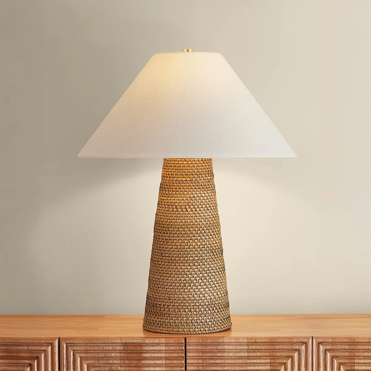 The Forest Heights table lamp reimagines a familiar silhouette with a distinctive materiality. A tightly coiled and lashed pencil rattan technique inspired by traditional Japanese basket weaving introduces a rich natural tonality and layered texture to the conical base. Amethyst Home provides interior design, new home construction design consulting, vintage area rugs, and lighting in the Austin metro area.