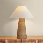 The Forest Heights table lamp reimagines a familiar silhouette with a distinctive materiality. A tightly coiled and lashed pencil rattan technique inspired by traditional Japanese basket weaving introduces a rich natural tonality and layered texture to the conical base. Amethyst Home provides interior design, new home construction design consulting, vintage area rugs, and lighting in the Austin metro area.