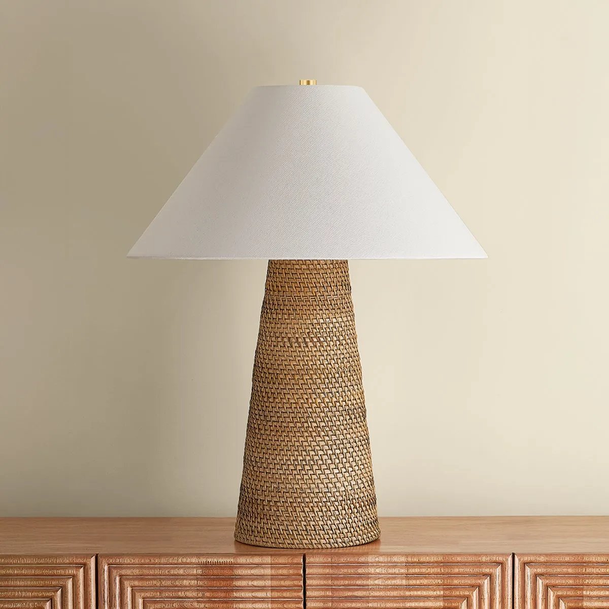 The Forest Heights table lamp reimagines a familiar silhouette with a distinctive materiality. A tightly coiled and lashed pencil rattan technique inspired by traditional Japanese basket weaving introduces a rich natural tonality and layered texture to the conical base. Amethyst Home provides interior design, new home construction design consulting, vintage area rugs, and lighting in the Houston metro area.