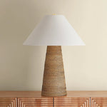 The Forest Heights table lamp reimagines a familiar silhouette with a distinctive materiality. A tightly coiled and lashed pencil rattan technique inspired by traditional Japanese basket weaving introduces a rich natural tonality and layered texture to the conical base. Amethyst Home provides interior design, new home construction design consulting, vintage area rugs, and lighting in the Houston metro area.