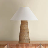 The Forest Heights table lamp reimagines a familiar silhouette with a distinctive materiality. A tightly coiled and lashed pencil rattan technique inspired by traditional Japanese basket weaving introduces a rich natural tonality and layered texture to the conical base. Amethyst Home provides interior design, new home construction design consulting, vintage area rugs, and lighting in the Houston metro area.
