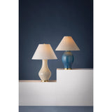 Artisanal and contemporary, Hanslope features a gracefully sculpted ceramic base paired with a crisp white linen shade. The unique form and proportions, coupled with the off-white French Muslin glaze give this lamp an earthy, organic feel. The glossy finish adds to the charm of this lovely everyday light fixture Amethyst Home provides interior design, new home construction design consulting, vintage area rugs, and lighting in the Tampa metro area.