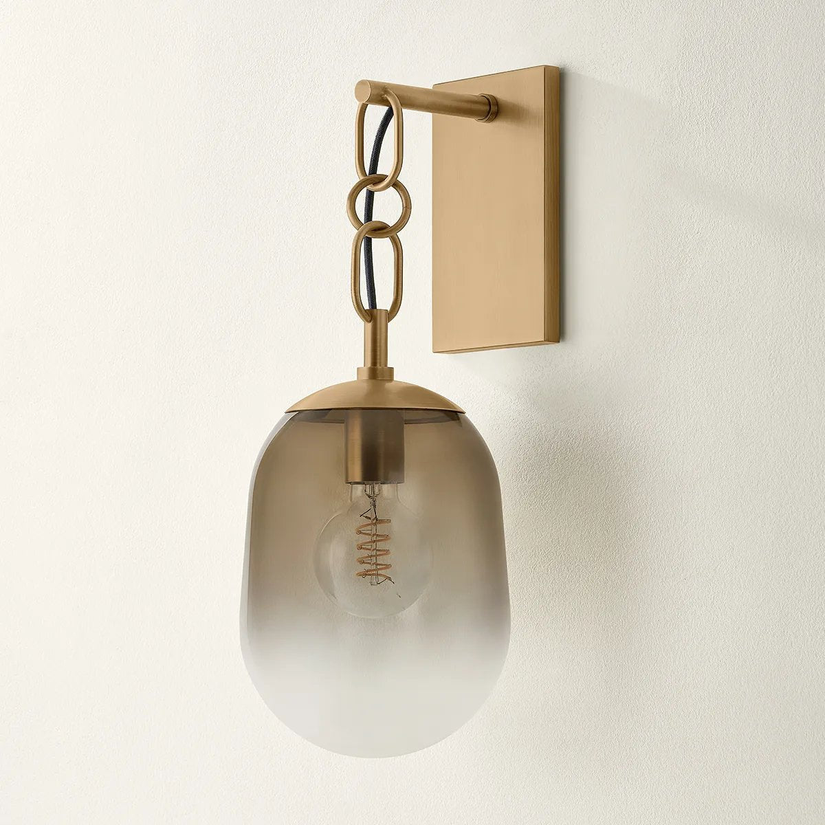 The Harvey chandelier’s dangling arms and artistic ombre glass are both Calderesque and faintly organic. Softly pill-shaped Dark Bronze glass shades drip from racetrack-shaped links on the sparse, arcing metal framework. The subtle industrial details provide a striking contrast to the otherwise playful silhouette. Amethyst Home provides interior design, new home construction design consulting, vintage area rugs, and lighting in the Winter Garden metro area.