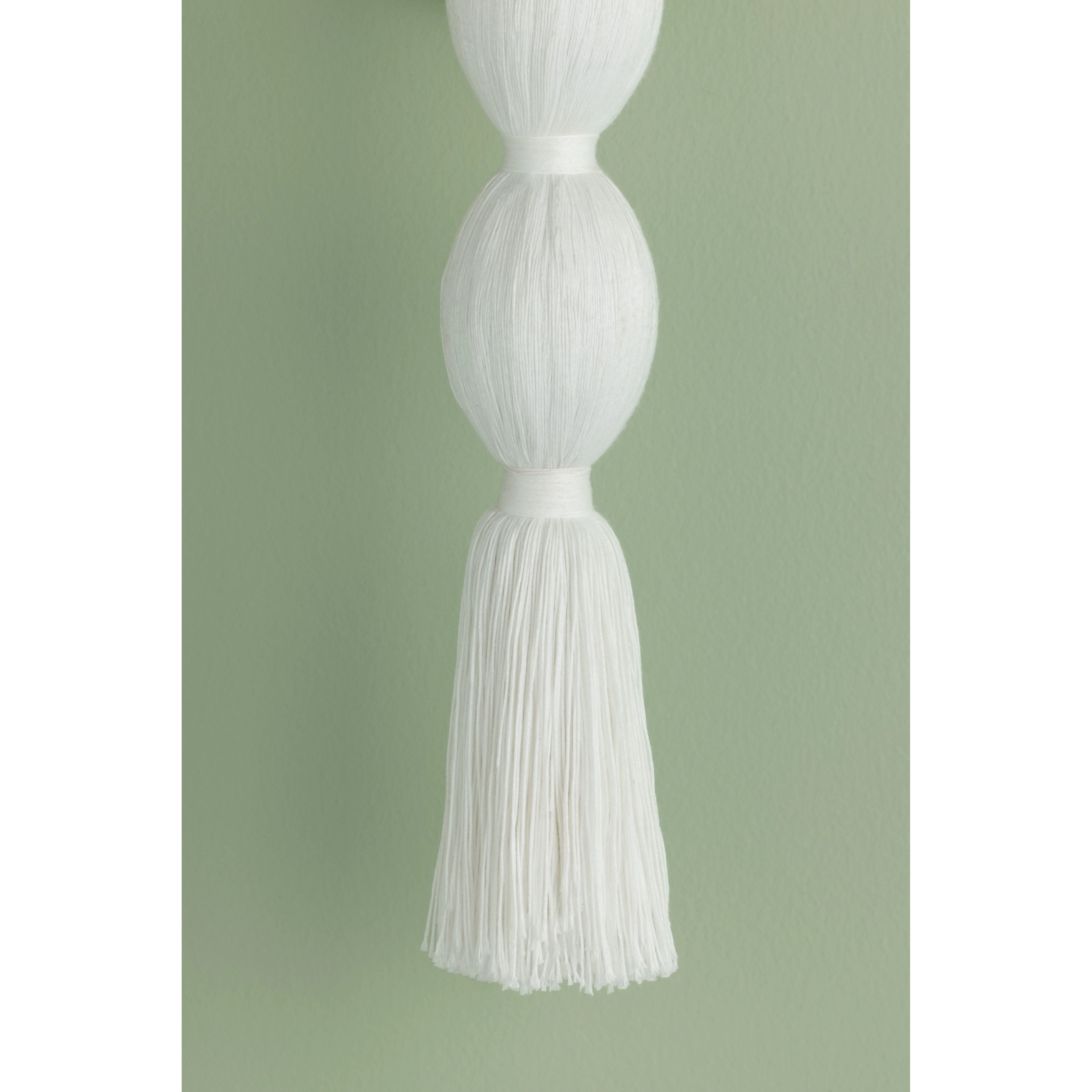 A celebration of authentic handicraft, the cinched silhouette of Indra resembles an elongated tassel. The cotton string and white linen shade create an all-over light, fresh appearance, accented by Aged Brass hardware at the neck. This single-light sconce serves as an artistic piece for small spaces in need of a spruce. Amethyst Home provides interior design, new home construction design consulting, vintage area rugs, and lighting in the San Diego metro area.