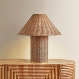 Woven from natural wicker, the Jeanette table lamp channels the inviting spirit of cottagecore with a bold, sculptural silhouette. A textural shade rests on a matching body, with a rim of decorative Aged Brass glimmering at the base. Perfect for a console, end table, or bedside, Jeanette infuses any space with a dose of charm Amethyst Home provides interior design, new home construction design consulting, vintage area rugs, and lighting in the Kansas City metro area.