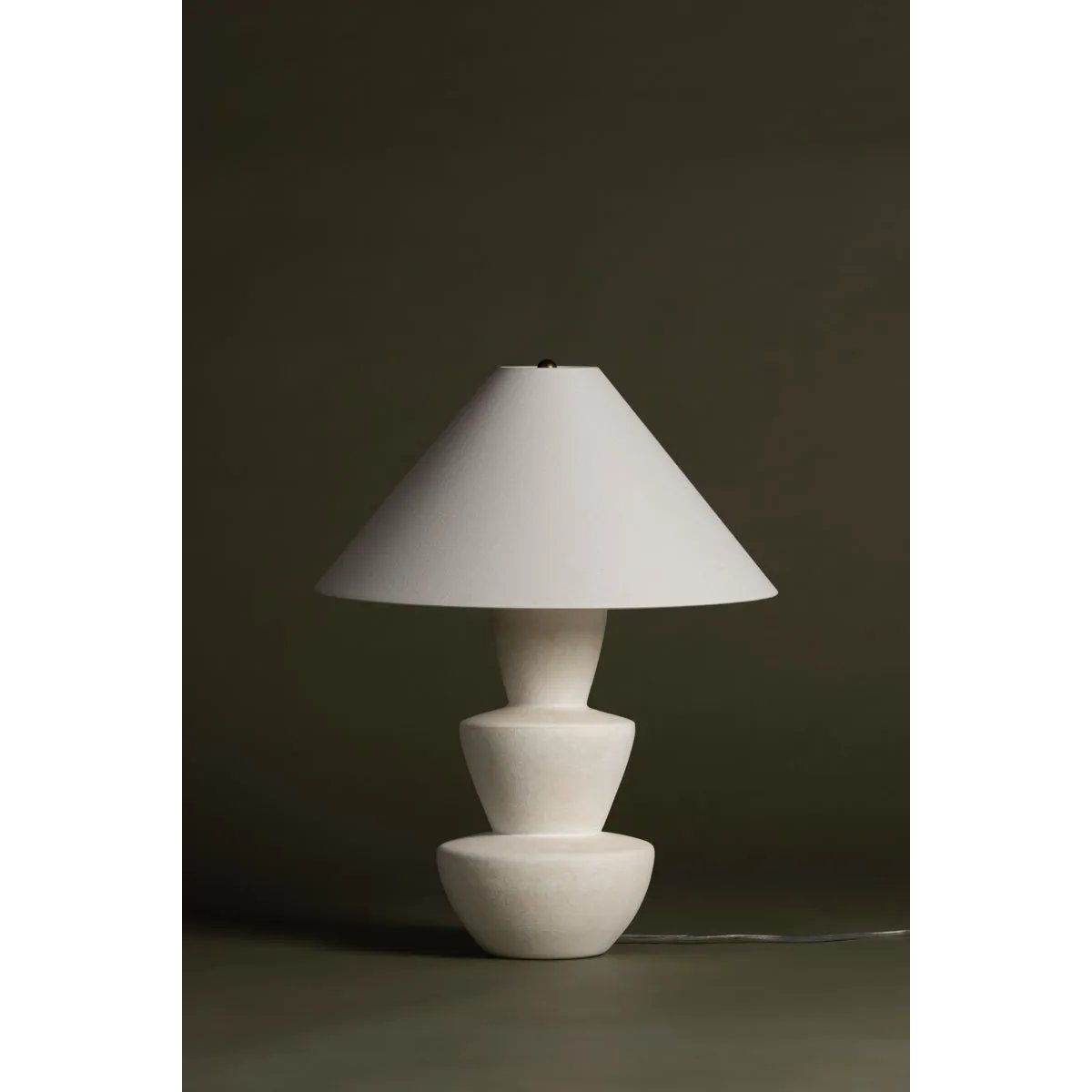 A series of three stacked, bowl-like shapes in ivory texture ceramic give this table lamp an organic, hand-crafted silhouette. The tapered off-white linen shade and Patina Brass accents add to the warm, natural beauty. Amethyst Home provides interior design, new home construction design consulting, vintage area rugs, and lighting in the Des Moines metro area.