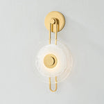 The earring-like design of Keuka Park exudes ornamental, graphic appeal. A thick disc of Blonchino Piastre glass is illuminated at the point where it attaches to the racetrack frame of this striking wall fixture. Whether finished in Aged Brass or Old Bronze, Keuka Park brings modernist artistry to any wall.  Amethyst Home provides interior design, new home construction design consulting, vintage area rugs, and lighting in the Calabasas metro area.
