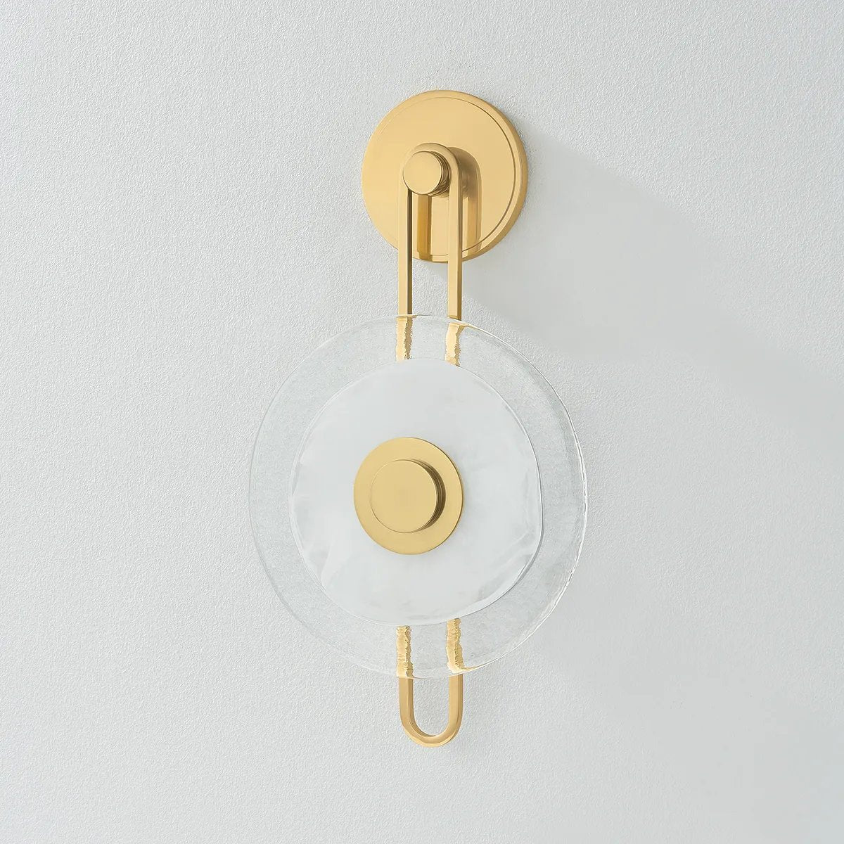 The earring-like design of Keuka Park exudes ornamental, graphic appeal. A thick disc of Blonchino Piastre glass is illuminated at the point where it attaches to the racetrack frame of this striking wall fixture. Whether finished in Aged Brass or Old Bronze, Keuka Park brings modernist artistry to any wall.  Amethyst Home provides interior design, new home construction design consulting, vintage area rugs, and lighting in the Laguna Beach metro area.