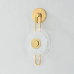 The earring-like design of Keuka Park exudes ornamental, graphic appeal. A thick disc of Blonchino Piastre glass is illuminated at the point where it attaches to the racetrack frame of this striking wall fixture. Whether finished in Aged Brass or Old Bronze, Keuka Park brings modernist artistry to any wall.  Amethyst Home provides interior design, new home construction design consulting, vintage area rugs, and lighting in the Laguna Beach metro area.