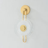 The earring-like design of Keuka Park exudes ornamental, graphic appeal. A thick disc of Blonchino Piastre glass is illuminated at the point where it attaches to the racetrack frame of this striking wall fixture. Whether finished in Aged Brass or Old Bronze, Keuka Park brings modernist artistry to any wall.  Amethyst Home provides interior design, new home construction design consulting, vintage area rugs, and lighting in the Laguna Beach metro area.