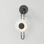The earring-like design of Keuka Park exudes ornamental, graphic appeal. A thick disc of Blonchino Piastre glass is illuminated at the point where it attaches to the racetrack frame of this striking wall fixture. Whether finished in Aged Brass or Old Bronze, Keuka Park brings modernist artistry to any wall.  Amethyst Home provides interior design, new home construction design consulting, vintage area rugs, and lighting in the Calabasas metro area.