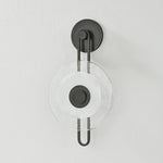 The earring-like design of Keuka Park exudes ornamental, graphic appeal. A thick disc of Blonchino Piastre glass is illuminated at the point where it attaches to the racetrack frame of this striking wall fixture. Whether finished in Aged Brass or Old Bronze, Keuka Park brings modernist artistry to any wall.  Amethyst Home provides interior design, new home construction design consulting, vintage area rugs, and lighting in the Salt Lake City metro area.