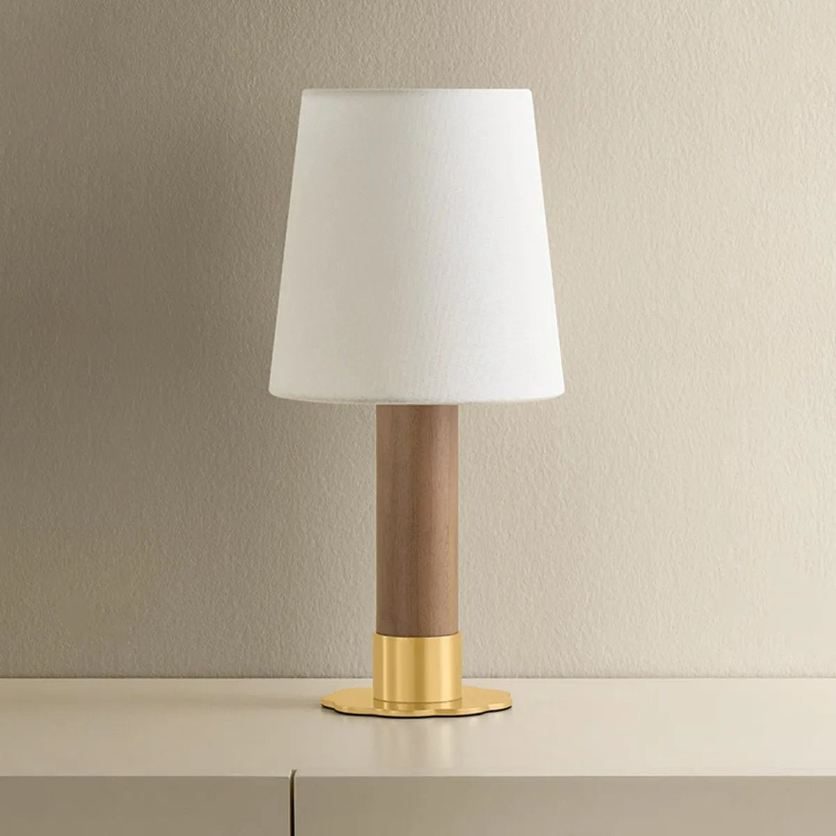 The Meadowbrook rechargeable lamp reinterprets a traditional silhouette with charming details. A beautifully grained light oak base rests upon a scalloped Aged Brass foot, introducing a graphic floral element. Topped with a classic white linen shade, the design balances decorative appeal with modern tailoring. Amethyst Home provides interior design, new home construction design consulting, vintage area rugs, and lighting in the Des Moines metro area.
