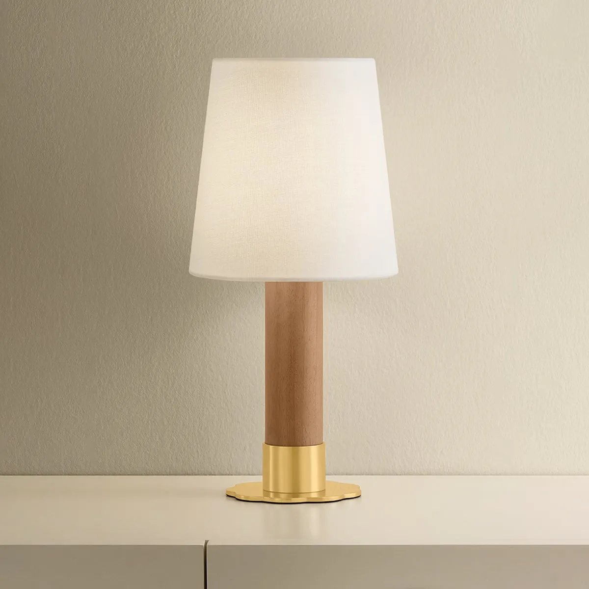The Meadowbrook rechargeable lamp reinterprets a traditional silhouette with charming details. A beautifully grained light oak base rests upon a scalloped Aged Brass foot, introducing a graphic floral element. Topped with a classic white linen shade, the design balances decorative appeal with modern tailoring. Amethyst Home provides interior design, new home construction design consulting, vintage area rugs, and lighting in the Seattle metro area.