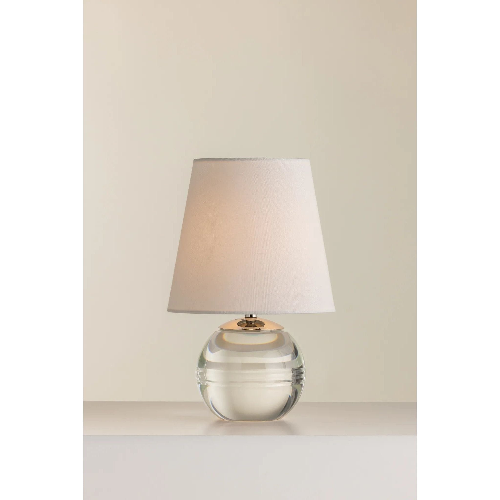 Ridged with ripple-like cuts, the crystal base of the Nicole table lamp makes for an eye-catching accent piece. Topped with a beautiful white linen shade, this pretty portable is rechargeable, adding convenience when styling. With classic Aged Brass-finished hardware, it’s the perfect addition to any bookshelf or small space. Amethyst Home provides interior design, new home construction design consulting, vintage area rugs, and lighting in the Austin metro area.