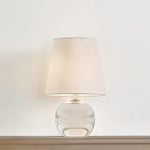Ridged with ripple-like cuts, the crystal base of the Nicole table lamp makes for an eye-catching accent piece. Topped with a beautiful white linen shade, this pretty portable is rechargeable, adding convenience when styling. With classic Aged Brass-finished hardware, it’s the perfect addition to any bookshelf or small space. Amethyst Home provides interior design, new home construction design consulting, vintage area rugs, and lighting in the Omaha metro area.