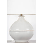 Inspired by rustic pottery, this table lamp's beautifully shaped base is crafted of pale sage ceramic giving it an earthy pale green tone. The off white linen shade pairs naturally and casts a soft glow. Raised seamlines and a reactive glaze that allows hints of the natural ceramic to peek through, give the fixture a hand-thrown, crafted feel. Amethyst Home provides interior design, new home construction design consulting, vintage area rugs, and lighting in the Newport Beach metro area.