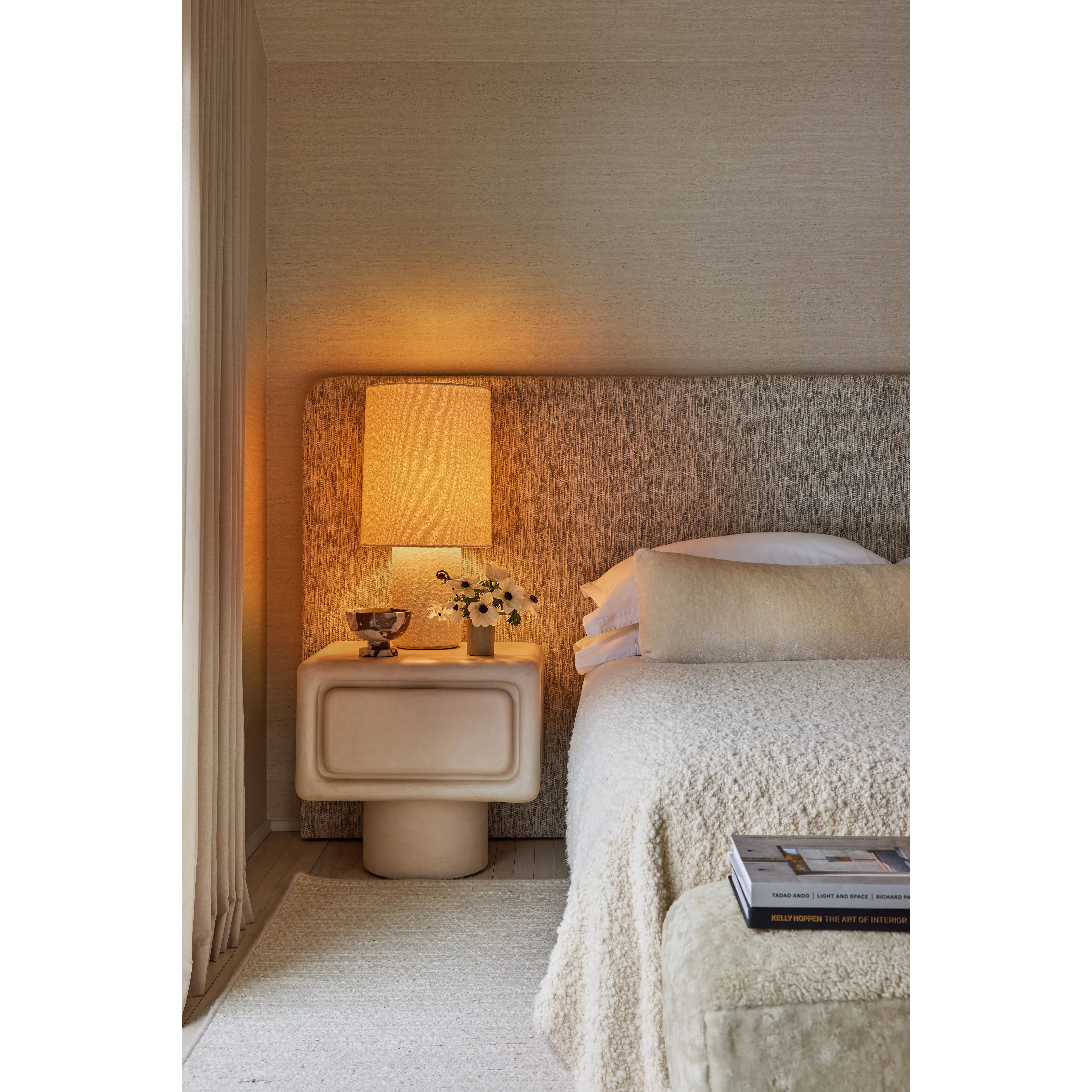 The all-over soft ivory boucle of the Sam family of lamps creates an inviting addition to modern interiors. As a table lamp, Sam makes a minimalist statement on a sideboard, while the floor lamp warms up a bedroom or reading nook with ease. The playful vertical proportions of both the table and floor lamp make them ideal for more narrow spaces. Amethyst Home provides interior design, new home construction design consulting, vintage area rugs, and lighting in the Park City metro area.