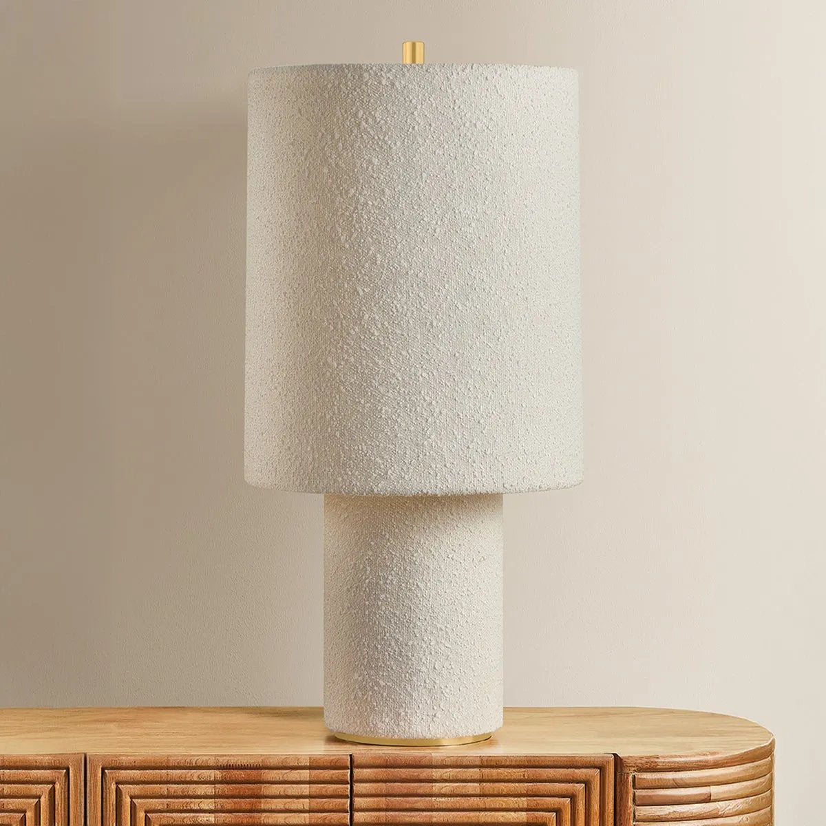 The all-over soft ivory boucle of the Sam family of lamps creates an inviting addition to modern interiors. As a table lamp, Sam makes a minimalist statement on a sideboard, while the floor lamp warms up a bedroom or reading nook with ease. The playful vertical proportions of both the table and floor lamp make them ideal for more narrow spaces. Amethyst Home provides interior design, new home construction design consulting, vintage area rugs, and lighting in the Tampa metro area.