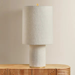 The all-over soft ivory boucle of the Sam family of lamps creates an inviting addition to modern interiors. As a table lamp, Sam makes a minimalist statement on a sideboard, while the floor lamp warms up a bedroom or reading nook with ease. The playful vertical proportions of both the table and floor lamp make them ideal for more narrow spaces. Amethyst Home provides interior design, new home construction design consulting, vintage area rugs, and lighting in the Tampa metro area.