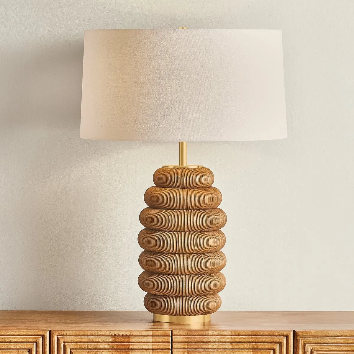 The lively Winbrook table lamp calls to mind the shape of a honeycomb. The voluminous base has been wrapped in natural pencil rattan, blending shape and material for a spin on the earthy, pillowy decor trend. Amethyst Home provides interior design, new home construction design consulting, vintage area rugs, and lighting in the Miami metro area.