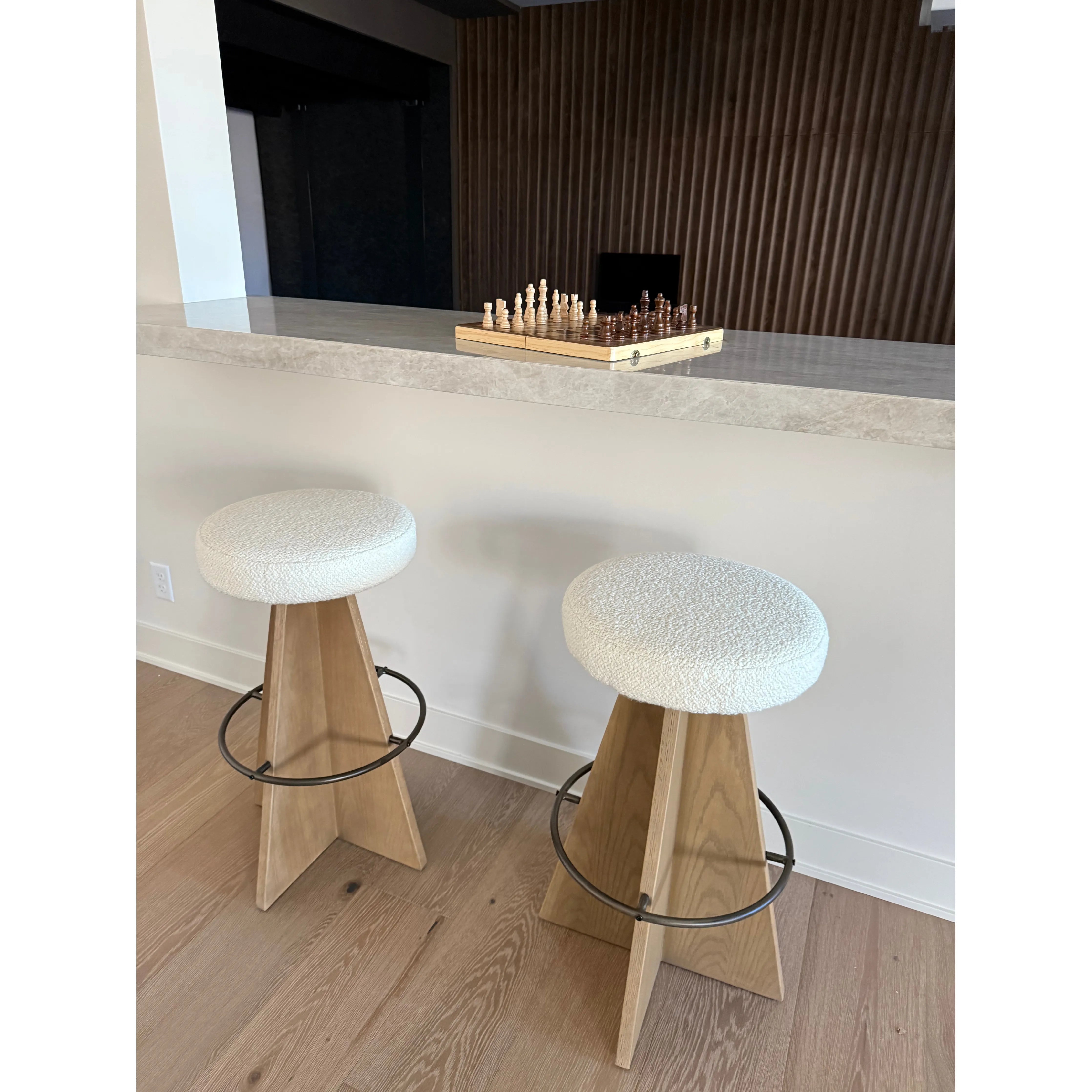 Featuring Damon Durham Cream Swivel Bar + Counter Stool by Four Hands at Amethyst Home. A gorgeous silhouette -- the Damon stool is an Amethyst fave.
Large angular panels merge to form a geometrically inspired base in this modern counter stool. The circle metal ring around the base serves as a footrest, while the round upholstered cushion provides comfortable. Amethyst Home provides interior design, new home construction design consulting, vintage area rugs, and lighting in the Houston metro area.