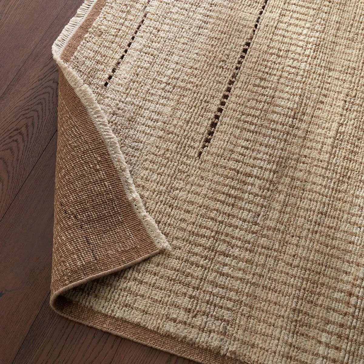 Full of texture, the handknotted Kazben Andar stuns with modern Moroccan patterns in natural hues. The Andar design delights with a taupe, tan, and brown linear pattern. A thin border adds the finishing touches to this elevated accent piece. Low, ribbed pile creates visual intrigue and grounds any contemporary space. Amethyst Home provides interior design, new home construction design consulting, vintage area rugs, and lighting in the Salt Lake City metro area.