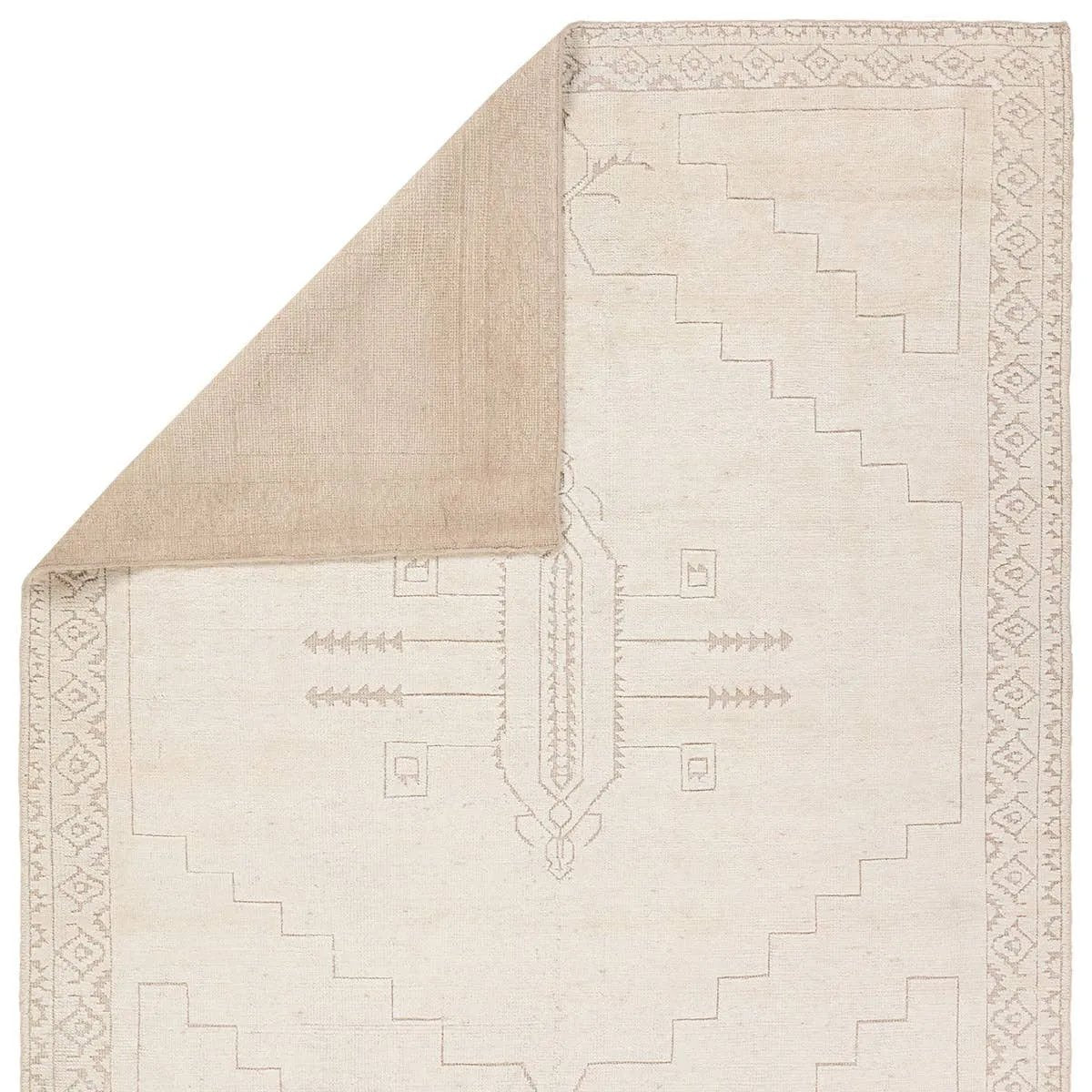 Hand carded wool, soft Tencel, and a neutral color palette define the handknotted Ashend Imbar. The Imbar rug showcases a Moroccan-inspired center medallion in a neutral, cream, taupe, and beige colorway. Geometric detailing via high and low pile establishes a thin border and provides a nod to the tribal styles of northern Africa. Amethyst Home provides interior design, new home construction design consulting, vintage area rugs, and lighting in the Austin metro area.