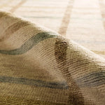 The Raza design reinvents the timeless plaid pattern, fusing classic charm with a modern edge. Soft beige tones, punctuated by a blue accent, elevate any mid-century modern space. Handcrafted from naturally stain-resistant wool, this rug handles medium-traffic areas, kids, and pets with ease. Amethyst Home provides interior design, new home construction design consulting, vintage area rugs, and lighting in the Alpharetta metro area.