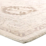 The Saffron design features a traditional pattern of small medallions, set against a warm tan and beige backdrop with subtle tan accents. Its vintage, distressed look adds character and charm, making it feel like a cherished heirloom from the very first step.Hand Tufte Amethyst Home provides interior design, new home construction design consulting, vintage area rugs, and lighting in the Portland metro area.